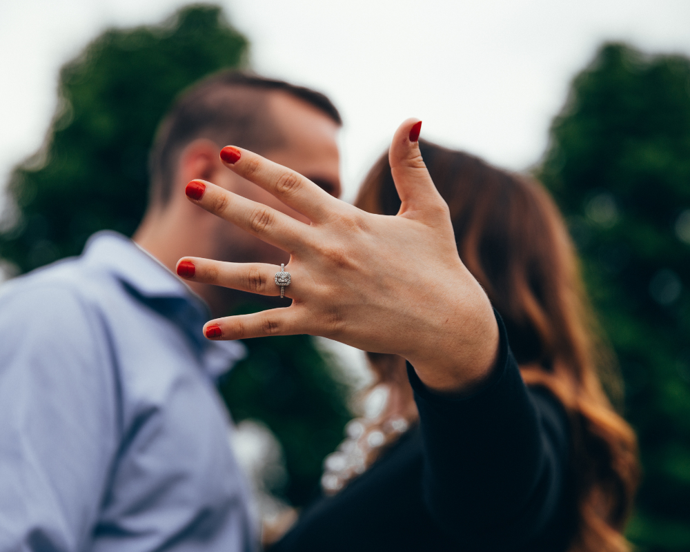 Happy couple with engagement ring